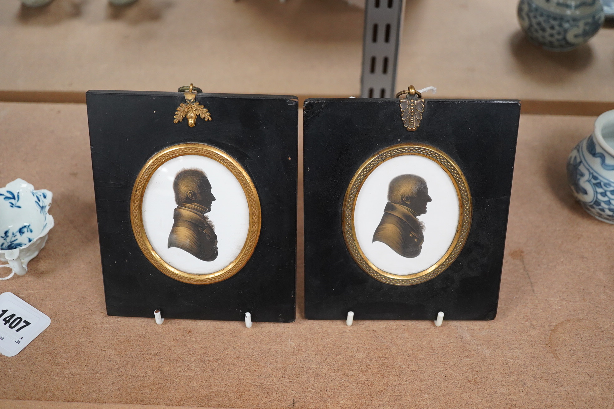 Miers & Field, two bronzed painted plaster silhouettes of gentlemen, framed. Condition - good